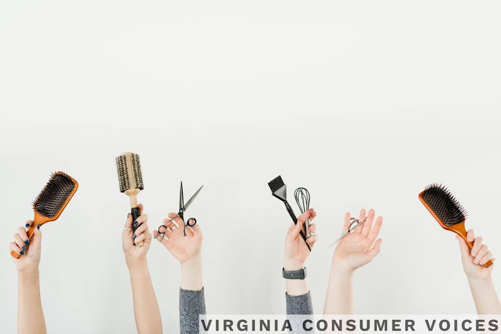 person holding silver and black hair brush