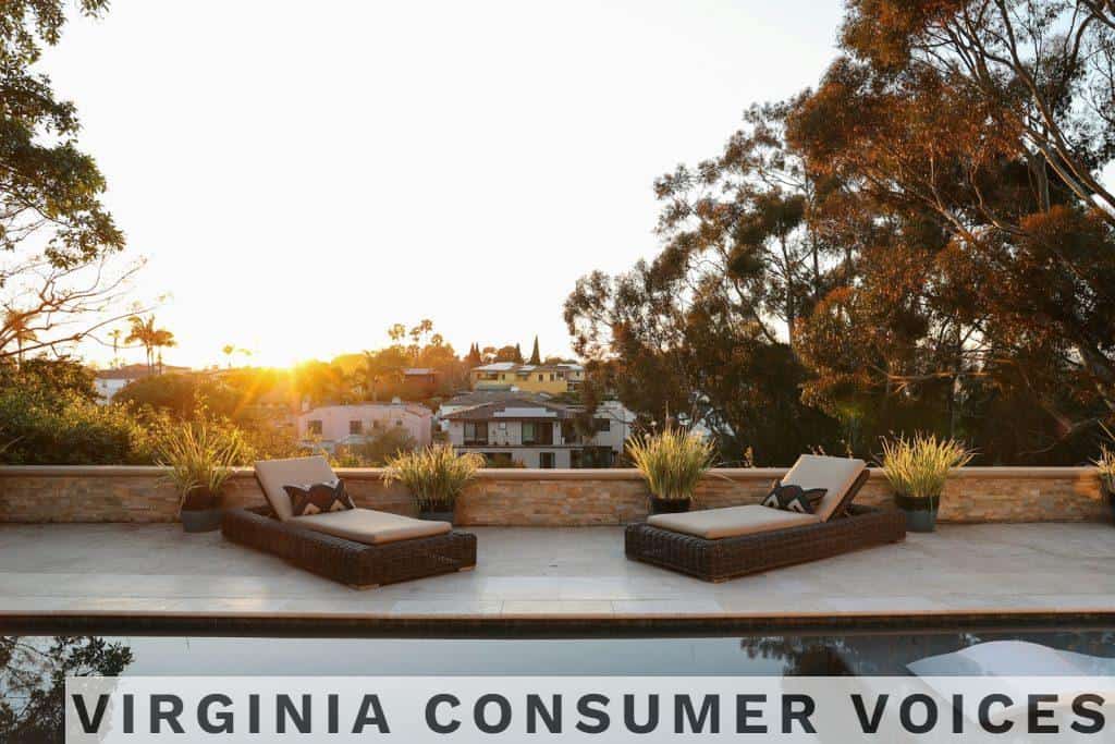 a pool with two lounge chairs and a view of a house