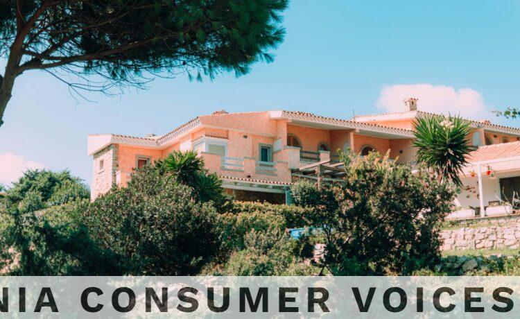 Charming Mediterranean villa nestled in vibrant, lush gardens under a clear blue sky.
